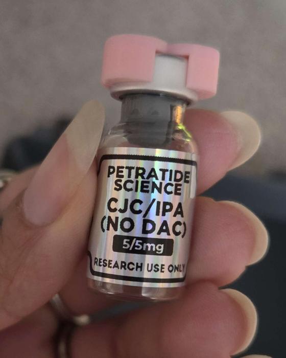 A Petratide Science vial with a pink cap